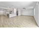 Open concept living room, dining and kitchen area with lots of natural light and wood-look tile floors at 584 S Andrea Cir, Haines City, FL 33844