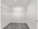 Walk-in closet with carpet floors and metal shelving, providing ample storage and organization solutions at 584 S Andrea Cir, Haines City, FL 33844