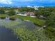 Beautiful aerial view of community pool, lake with dock and lily pads, and clubhouse at 6019 Crystal View Dr, Orlando, FL 32819