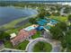 Beautiful aerial view of the community clubhouse, tennis courts, pool and lake at 6019 Crystal View Dr, Orlando, FL 32819
