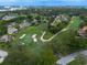 An aerial view of homes nestled on a golf course surrounded by lush greenery at 6019 Crystal View Dr, Orlando, FL 32819