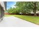 The backyard features a concrete patio, green grass, and a wood fence at 6019 Crystal View Dr, Orlando, FL 32819