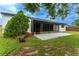 The backyard features a screened patio and a green lawn with landscaping at 6019 Crystal View Dr, Orlando, FL 32819