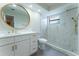 Bright bathroom featuring a marble tiled walk-in shower and white vanity with gold fixtures at 6019 Crystal View Dr, Orlando, FL 32819