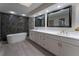 Bathroom featuring a modern vanity with dual sinks and a luxurious freestanding tub at 6019 Crystal View Dr, Orlando, FL 32819
