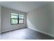 Bedroom featuring hard surface floors and a large window overlooking greenery at 6019 Crystal View Dr, Orlando, FL 32819