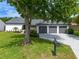 Charming home with well-maintained lawn, mature trees, and a three-car garage at 6019 Crystal View Dr, Orlando, FL 32819