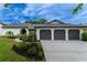 Charming single-story home with a three-car garage and well-manicured landscaping at 6019 Crystal View Dr, Orlando, FL 32819