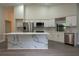 Bright kitchen with stainless steel appliances, island with bar seating and white marble accents at 6019 Crystal View Dr, Orlando, FL 32819