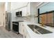 Modern kitchen features stainless steel appliances, white cabinets, and sleek gold fixtures at 6019 Crystal View Dr, Orlando, FL 32819