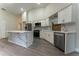 Bright open kitchen featuring stainless steel appliances, sleek white cabinets, and a large marble island at 6019 Crystal View Dr, Orlando, FL 32819
