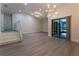 Spacious living room featuring modern light fixtures, and sliding glass doors that provide a seamless indoor-outdoor flow at 6019 Crystal View Dr, Orlando, FL 32819