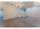 Bright living room with vaulted ceilings, light wood floors, and modern chandelier at 6019 Crystal View Dr, Orlando, FL 32819
