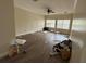 Spacious living room with wood-look flooring, abundant natural light, and a ceiling fan at 6230 Cranberry Dr, Port Orange, FL 32127
