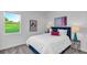 Comfortable bedroom with stylish furnishings, a cozy bed, and bright natural light from a large window at 648 Terrapin Dr, Debary, FL 32713
