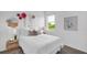 Charming bedroom with a cozy bed, decorative pillows, and a bright window with a lush green view at 648 Terrapin Dr, Debary, FL 32713