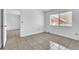 Empty bedroom showcasing a large window and neutral-colored tile flooring at 664 Kenwick Cir # 104, Casselberry, FL 32707