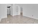 Empty bedroom showcasing neutral-colored tile flooring and a standard closet at 664 Kenwick Cir # 104, Casselberry, FL 32707