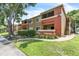 Condominium building featuring well-manicured lawns, mature trees, and inviting outdoor spaces at 664 Kenwick Cir # 104, Casselberry, FL 32707