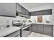 Traditional kitchen featuring black cabinetry, white countertops and stainless steel appliances at 664 Kenwick Cir # 104, Casselberry, FL 32707