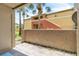 View of the exterior from the screened patio with view of tropical landscape at 664 Kenwick Cir # 104, Casselberry, FL 32707