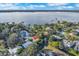 Waterfront property with lush landscaping and trees; lake is near city, offering access to a beautiful body of water at 6805 Barby Ln, Belle Isle, FL 32812