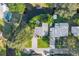 Stunning aerial view of a home with a backyard fire pit, waterfront access, a private dock, and a swimming pool at 6805 Barby Ln, Belle Isle, FL 32812