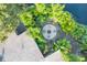 Aerial view of a private backyard with a charming fire pit and lush greenery at 6805 Barby Ln, Belle Isle, FL 32812