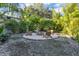 Inviting backyard fire pit surrounded by lush landscaping and seating at 6805 Barby Ln, Belle Isle, FL 32812