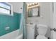 Fresh bathroom with a tub, shower, white vanity, and aqua tile at 6805 Barby Ln, Belle Isle, FL 32812