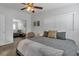 Bright bedroom showcasing a comfortable queen bed, mirrored closet, and neutral decor at 6805 Barby Ln, Belle Isle, FL 32812