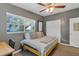 Comfortable bedroom with natural light, a mirrored closet, and neutral tones at 6805 Barby Ln, Belle Isle, FL 32812