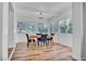 Airy dining room featuring hardwood floors and bright window views at 6805 Barby Ln, Belle Isle, FL 32812