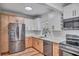 Bright kitchen with stainless steel appliances, two-tone cabinets, plenty of countertop space and wood-look flooring at 6805 Barby Ln, Belle Isle, FL 32812