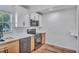 Updated kitchen featuring stainless steel appliances, including a range, microwave and dishwasher, and two-tone cabinets at 6805 Barby Ln, Belle Isle, FL 32812