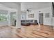 Open-concept living room with hardwood floors, comfortable seating, and ample light at 6805 Barby Ln, Belle Isle, FL 32812