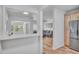 Open-concept living area flows from the kitchen, featuring an adjacent living room with recessed lighting and wood-look floors at 6805 Barby Ln, Belle Isle, FL 32812