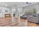 Spacious living room with hardwood floors, plush seating, and large windows at 6805 Barby Ln, Belle Isle, FL 32812