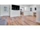 Bright living room with hardwood floors, a modern TV, and ample natural light at 6805 Barby Ln, Belle Isle, FL 32812
