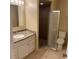 Bathroom featuring a granite countertop vanity and walk-in shower with glass door at 7266 Oak Meadows Cir, Orlando, FL 32835