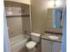 Bright bathroom featuring a granite vanity top, and a tiled shower and tub at 7266 Oak Meadows Cir, Orlando, FL 32835