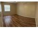 Bright bedroom featuring laminate floors and a window at 7266 Oak Meadows Cir, Orlando, FL 32835