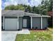 Charming single-story home with a well-maintained lawn and a garage, offering an inviting curb appeal at 7266 Oak Meadows Cir, Orlando, FL 32835
