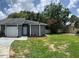 Cozy single-story home featuring a lovely front yard, a garage, and an inviting entrance at 7266 Oak Meadows Cir, Orlando, FL 32835