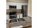 Charming kitchen featuring stainless steel appliances and granite countertops at 7266 Oak Meadows Cir, Orlando, FL 32835