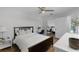 Bedroom features wood floors, a ceiling fan, and space for a small desk, with a view to the walk-in closet at 7742 Sugar Bend Dr # 7742, Orlando, FL 32819