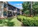 Rear exterior view of condos with screened lanais overlooking lush landscaping at 7742 Sugar Bend Dr # 7742, Orlando, FL 32819