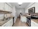 Bright kitchen featuring granite countertops, stainless steel appliances, and wood floors at 7742 Sugar Bend Dr # 7742, Orlando, FL 32819