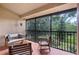 Spacious screened-in porch with cozy seating and a peaceful view of the surrounding greenery at 7742 Sugar Bend Dr # 7742, Orlando, FL 32819