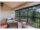 Inviting screened-in porch featuring comfortable seating and views of lush greenery at 7742 Sugar Bend Dr # 7742, Orlando, FL 32819